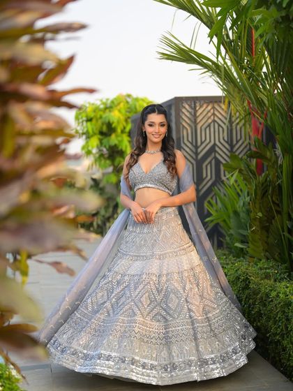 A full-length shot showing the entire luminous look. The makeup, hair, and outfit come together to create a truly magical and glamorous transformation.