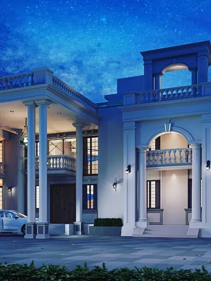 A dramatic night view of the same classical residential building. The architectural lighting is designed to accentuate the majestic columns and arched openings, creating a powerful and opulent statement.
