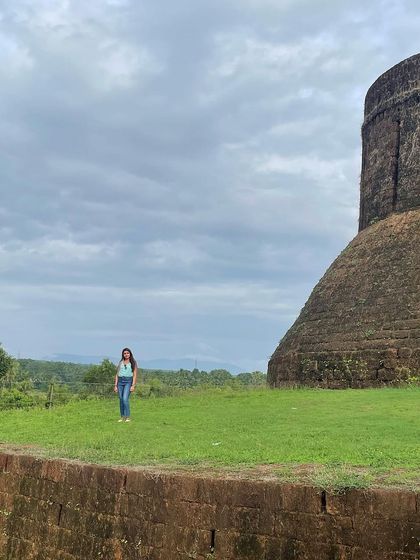 A trekker posing at the historic Kavaledurga Fort.
