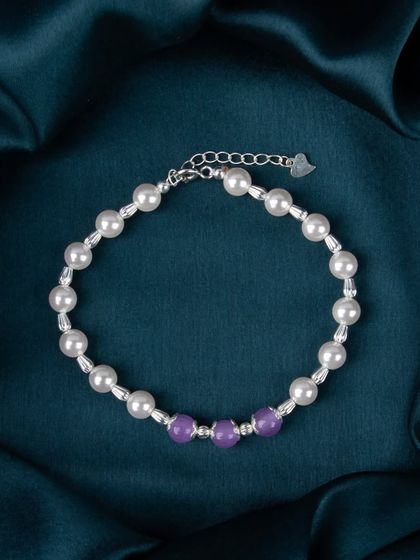 A pearl and purple bead bracelet, adding a subtle touch of color.