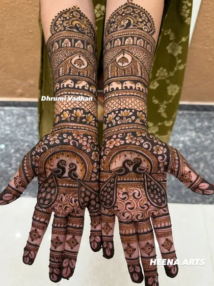 A stunning example of symmetrical peacock designs, a classic choice for Indian wedding mehendi that symbolizes grace and beauty.