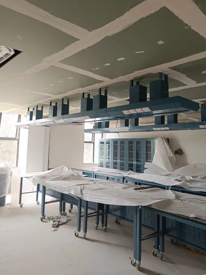 A science lab under construction at Heritage Xperiential School. The image reveals the installation of lab benches and ventilation hoods, showcasing the specialized planning required for practical learning spaces.