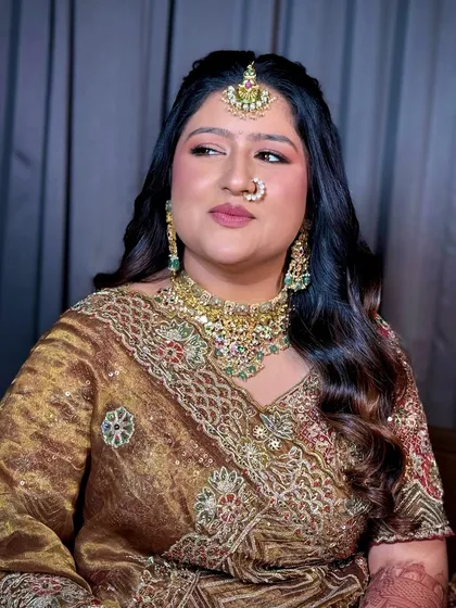 A close-up showing the soft glam eye makeup and the perfectly blended skin. The look is elegant and enhances her natural beauty.