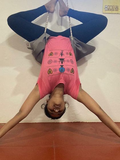 Using props like wall ropes is a key part of my teaching method for advanced poses. Here you can see my students in an inverted Baddha Konasana (Bound Angle Pose), using the ropes to decompress the spine and open the hips safely.