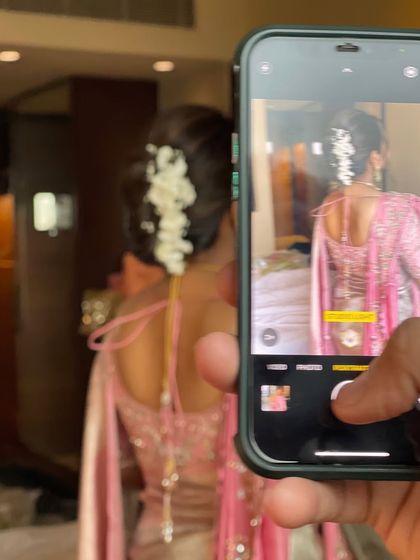 A behind the scenes shot of me capturing the perfect photo of my work. I believe in showcasing the final hairstyle in the best possible light.