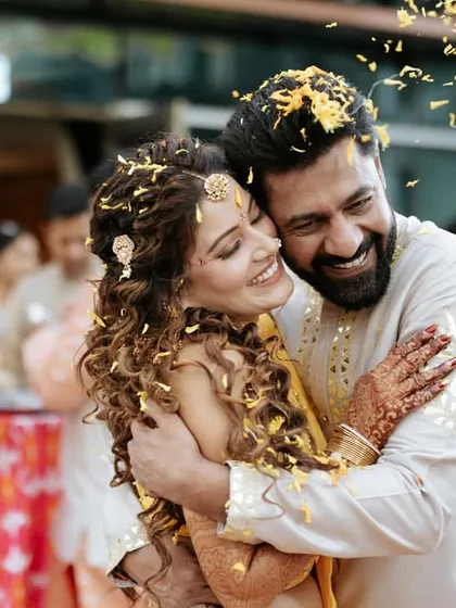 It's the candid, in-between moments that hold the most love. A happy hug amidst a shower of petals during the Haldi ceremony captures the pure, unfiltered joy we strive to create for our couples.