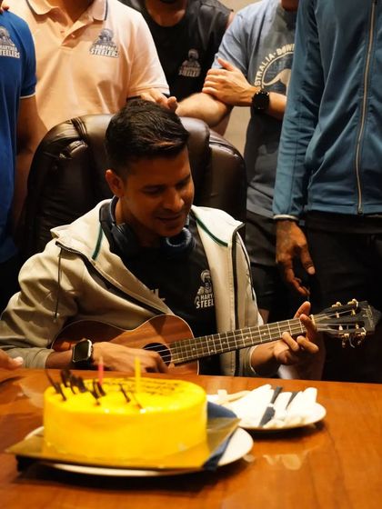 Taking a moment to play some music for the team during a celebration. Building a positive team environment is a key part of my coaching philosophy.