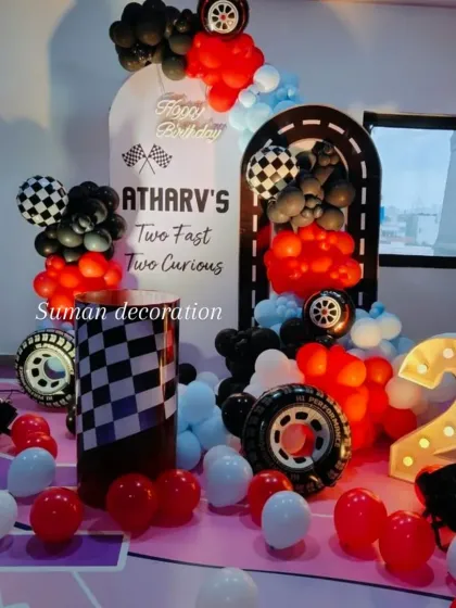 The full view of the car racing party setup, complete with a large light-up number '2' to celebrate the milestone.