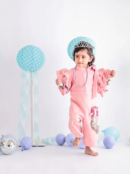 Dancing into her second year! This action shot captures the energy of a toddler's birthday, with a fun pastel and disco ball theme to celebrate turning two.