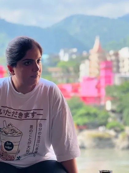A moment of thought against the vibrant backdrop of Rishikesh. The contrast between the inner quiet and the outer world is a powerful lesson in itself.