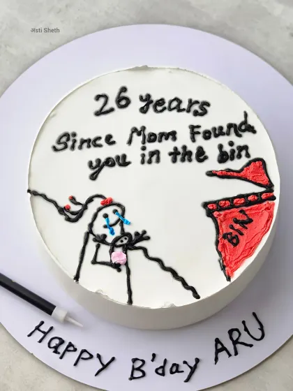 The final presentation of the funny "bin" cake, with the birthday message written on the board.