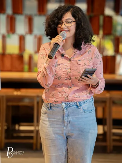 A performer shares a laugh with the audience. Our themed events are not just serious; they are also filled with joy, connection, and community spirit.