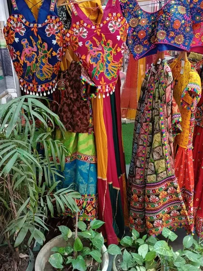 A glimpse into my boutique, showcasing a variety of colorful and intricately embroidered blouses and lehengas ready for the Navratri season.