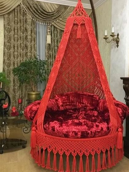 A vibrant red swing that adds a pop of color and luxury to any room. The velvet cushion makes it extra plush and comfortable.