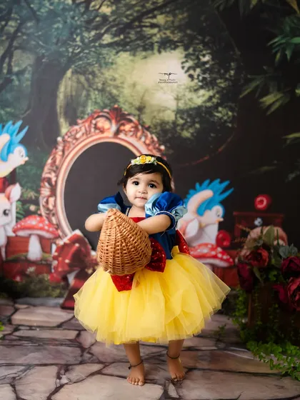 This little princess is ready for a walk through the woods with her basket. The Snow White theme is a timeless choice for a magical birthday or milestone shoot.