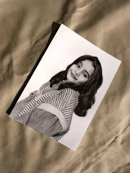 The Varanasi portrait, photographed on a textured fabric background for an artistic touch.