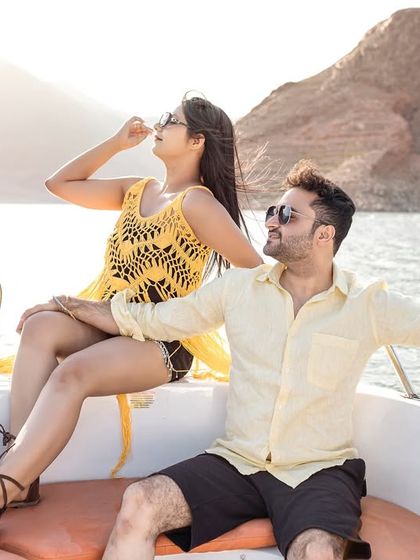 A stylish, candid-style shot of the couple relaxing on the speedboat. This shows a more modern and fun side to a pre-wedding boat shoot.