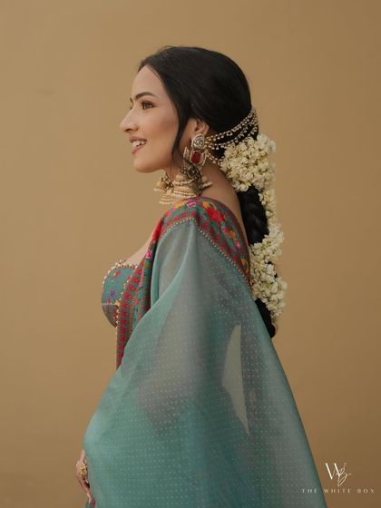 A side profile highlighting the beautiful gajra and the natural contour of her face.