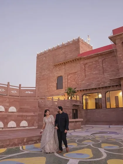 A wide shot of the couple in the courtyard of a beautiful heritage property. We use grand locations to create epic and memorable wedding portraits.