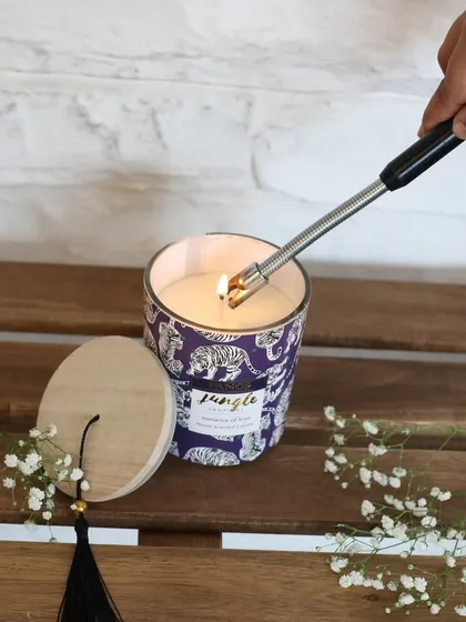 This scented candle features a beautiful jungle-themed print and a wooden lid with a tassel. It’s a perfect piece for those who love a touch of the wild in their home decor.