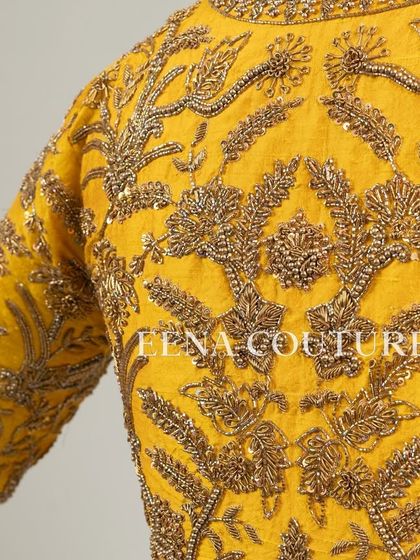 This sunshine yellow raw silk blouse is brought to life with meticulous hand embroidery by my talented artisans. The dense, traditional motifs in antique gold threadwork cover the back and sleeves, creating a piece that radiates warmth and luxury.