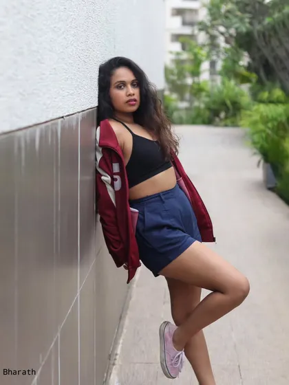 A leaning pose against a white wall, creating a clean and modern composition for this sporty look.