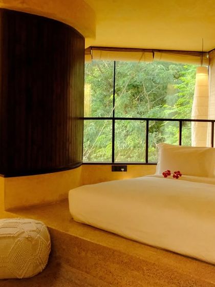 A suite designed for rest and rejuvenation, where the bed becomes a private island of comfort with the forest just beyond the window.