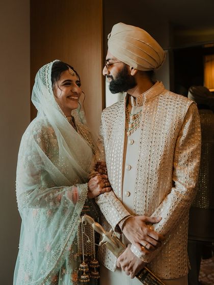 A candid, happy moment between the Punjabi bride and groom before their ceremony. Their smiles and easy chemistry are beautifully captured.