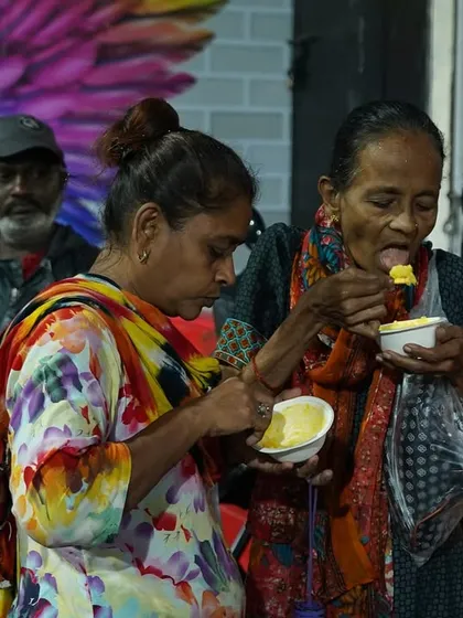 People from the community enjoying the food served from our Annam Brahma van. We take our mission to the streets to reach those in need wherever they are.