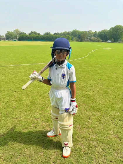 The future of cricket. This young player has the dream in his eyes and the bat in his hand.