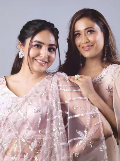 Two models, two beautiful pastel outfits. This image showcases our baby pink Indo-Western saree alongside a matching lehenga, demonstrating our 'Yuthika' collection's cohesive and feminine aesthetic.