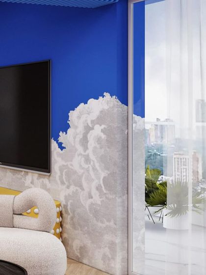The cloud motif continues on the TV wall, blurring the lines between the wall and the sky outside.