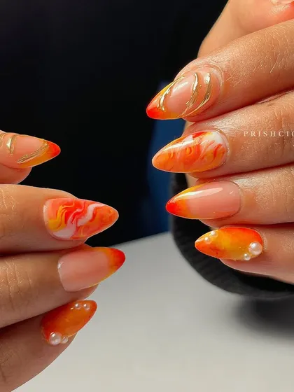 Another view of the orange marble and chrome set, showing how the different designs on each nail work together.