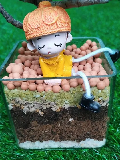 A close-up of the little character relaxing in the jade plant terrarium. It's these small details that make a plant arrangement special and personal.