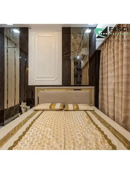 A bedroom at Lodha Belair with a bold design featuring dark marble-like panels and gold accents. The full-length mirrors on the wardrobe create an illusion of a larger, more opulent space.