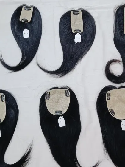 This image displays the underside of several hair toppers, showing the different base sizes and clip configurations I offer. Each one is designed to address different levels of hair thinning.