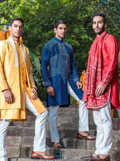 A dynamic shot of the vibrant trio of kurta sets. This image captures the energy and style of our diverse range, perfect for any wedding celebration.