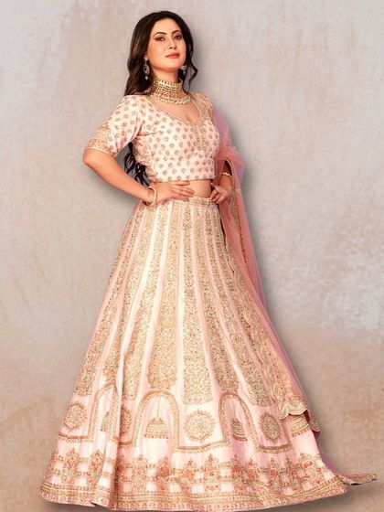 This baby pink lehenga with intricate gold embroidery is a dreamy and feminine choice for any special occasion.