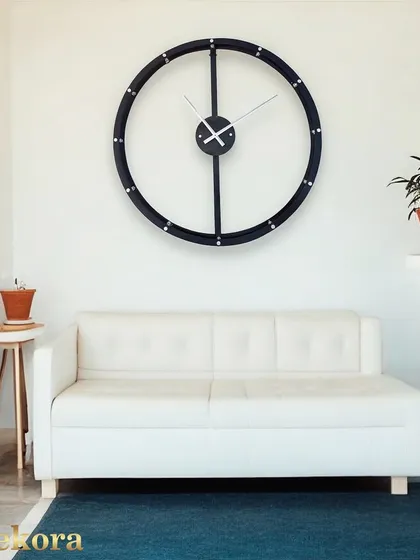 This oversized minimalist clock makes a powerful statement with its simple black metal ring and clean lines, ideal for spacious, contemporary interiors.