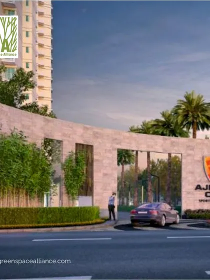 The grand entrance of Ajnara Sports Residency, a project where our landscape design creates a powerful first impression. The modern gate design, flanked by lush bamboo and palm trees, sets a tone of exclusivity and sophistication for the commercial and residential areas within.