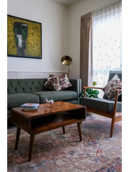 A detail of the living room, showing an exquisite artwork by Basuki Dasgupta that served as the inspiration for the yellow and green tones used throughout the space.