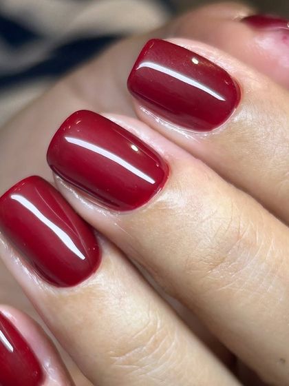 A classic, bold red manicure on short, square nails. The color is rich and the application is flawless, a testament to our Russian manicure technique.