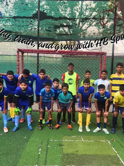 "Play, train, and grow with HB Sports!" Our youth football team poses together, a testament to the positive and growth-oriented environment we foster.