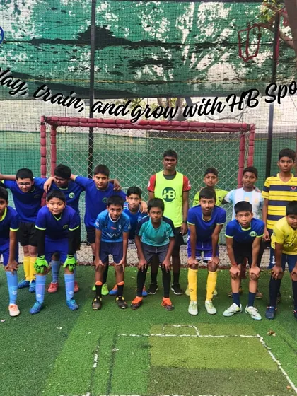 "Play, train, and grow with HB Sports!" Our youth football team poses together, a testament to the positive and growth-oriented environment we foster.
