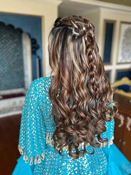 A beautiful braided half-up style with highlights.