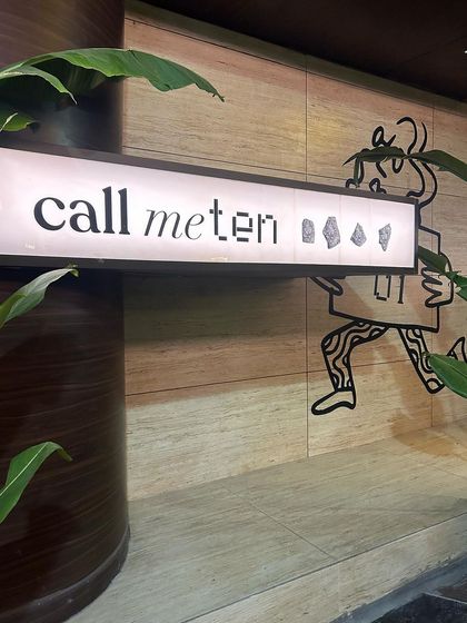 The entrance to "Call Me Ten," where the wall surfaces I provided create a warm and intriguing first impression. The travertine-style tiles set a natural, earthy tone for this escape from the ordinary.