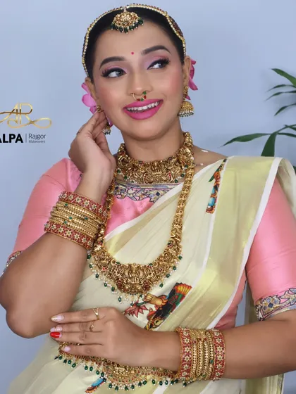 A side profile that gives a great view of the jhumkas and the floral hair arrangement.
