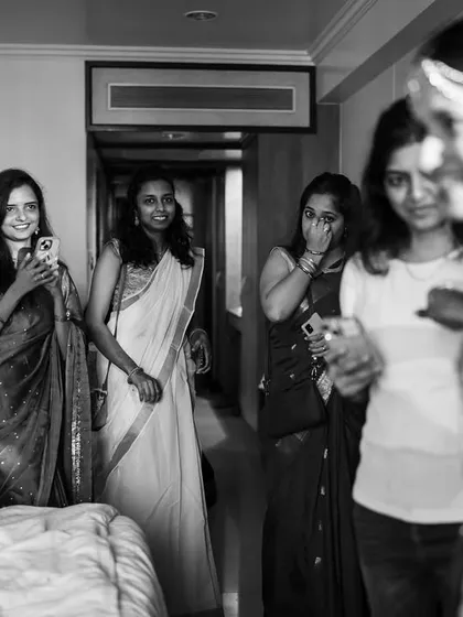 The bridesmaids' excited reactions as they see the bride fully ready for the first time. A moment of pure joy and friendship.