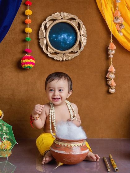 This baby Krishna is here to steal our hearts, with a mischievous smile and a pot of 'makhan' in our colorful Janmashtami set.