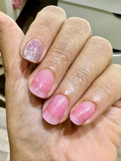 I love these subtle pink shimmer nails. They were done on the client's natural nails for a soft and pretty look.